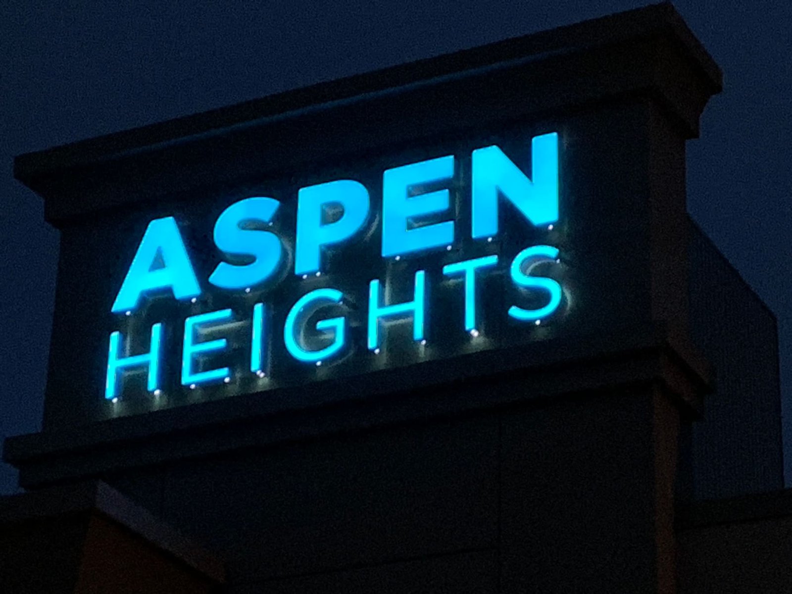 Aspen Heights channel letters lit up at night